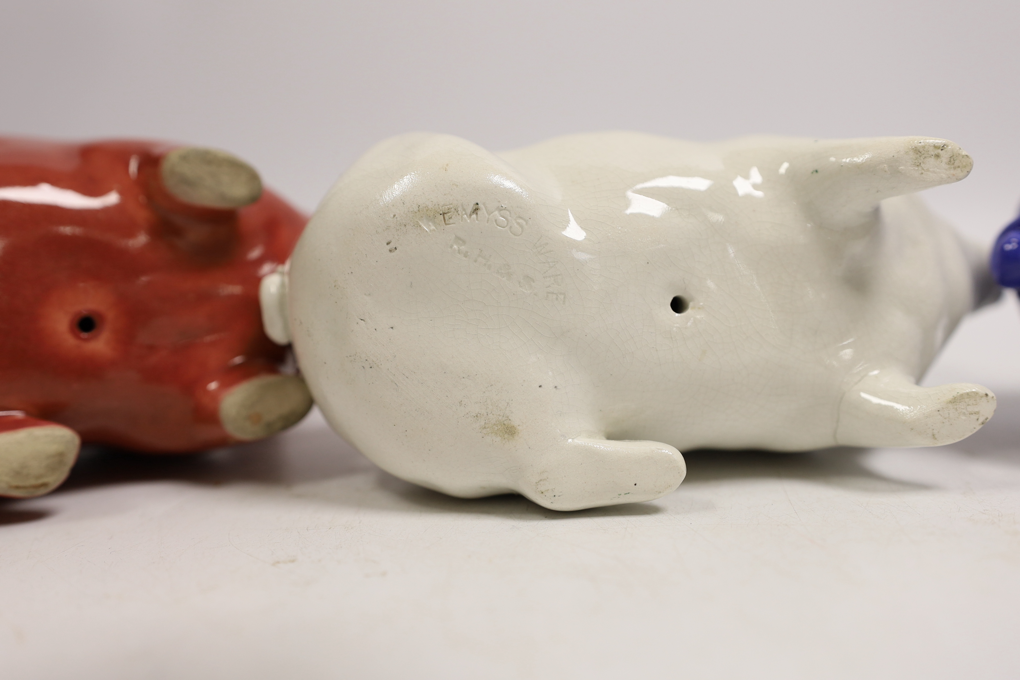 Three Wemyss ware pigs in cream, blue and pink glazes, 15cm